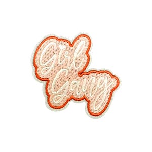 May include: Pink and orange embroidered patch with the text "Girl Gang" in white.
