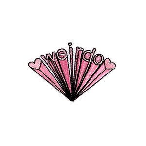May include: Pink embroidered patch with the text "weirdo" in a stylized font with two hearts on either side of the text.