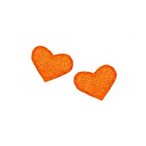 May include: Two orange felt hearts.