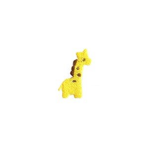 May include: A yellow embroidered giraffe with brown spots. The giraffe is standing on a white background.