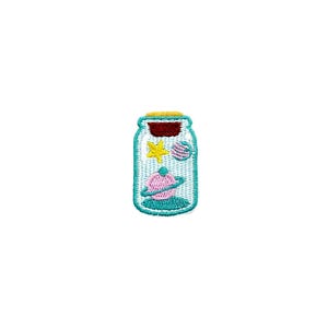 May include: A white glass jar with a teal lid and a yellow, pink, and blue star and planet design.