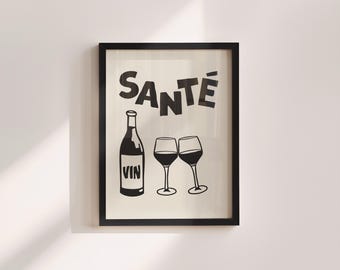 May include: Black and white framed art print featuring a wine bottle labeled "VIN" and two wine glasses. The word "SANTÉ" is printed above the bottle and glasses. The artwork is displayed on a white wall.