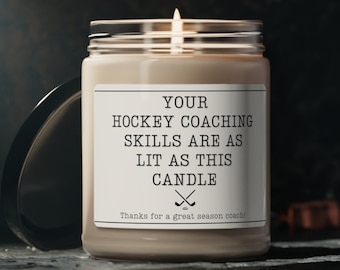 May include: A brown candle with a white label that reads "Your hockey coaching skills are as lit as this candle" with a hockey stick graphic. The text "Thanks for a great season coach!" is printed below the graphic.