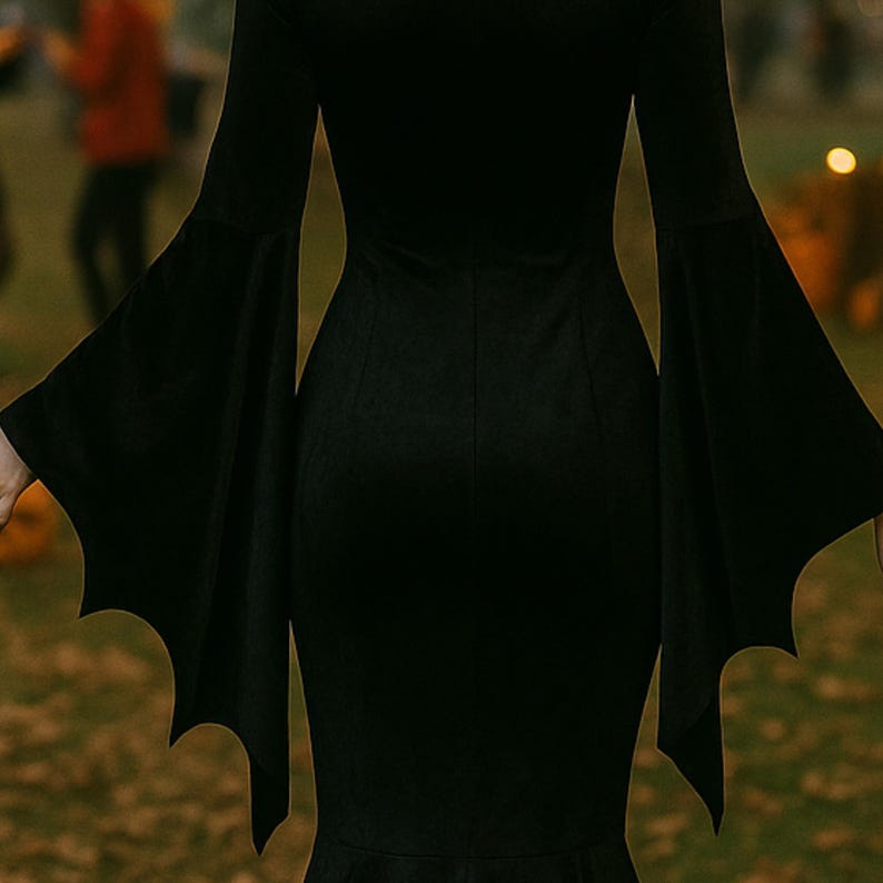 May include: A black dress with batwing sleeves. The sleeves are long and flared, with a bat-wing shape at the ends. The dress has a fitted bodice and a flared skirt. The dress is made of a soft, flowing fabric.