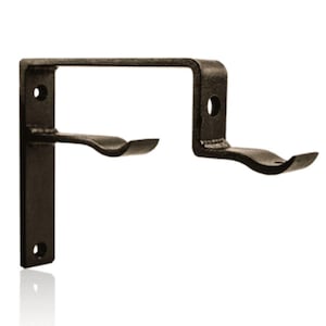 May include: A black metal double curtain rod bracket featuring a vertical mounting plate with two circular screw holes and two horizontal arms with curved cradles designed to hold two separate rods in a tiered, stepped configuration.
