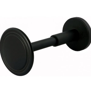 May include: A matte black curtain rod bracket featuring a cylindrical central bar and two circular end plates. The design includes a smooth finish with a raised circular detail on the front-facing disc, providing a clean and functional hardware component.