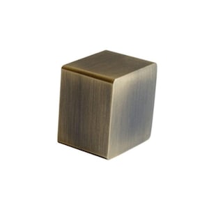 May include: A square-shaped, antique brass cabinet knob with a slightly rounded top.