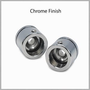May include: Two chrome finish cylindrical objects with a shiny, reflective surface. Each has a circular opening and a small, raised detail on top. The text "Chrome Finish" is above the objects.