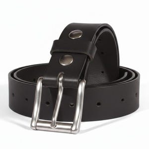 May include: A black leather belt with a silver-colored buckle. The belt is rolled up, showing the buckle and the belt's holes. The belt has two silver rivets near the buckle. The background is white.