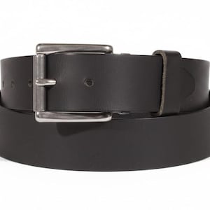 May include: A black leather belt with a silver-colored rectangular buckle. The belt is rolled up, showing the full width and thickness of the leather. The buckle is a simple, classic design.