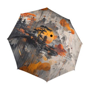 May include: A black and gray umbrella with a colorful abstract design featuring a Japanese-inspired landscape with a yellow sun, orange and gray mountains, and a black silhouette of a pagoda. The design also includes orange and gray splatters of paint.
