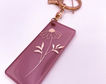 Dusty pink keyring with gold daisy decal.