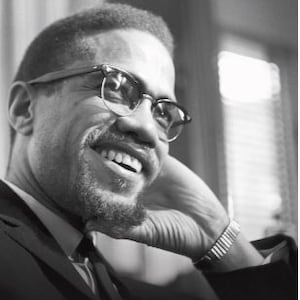 May include: Black and white photograph of Malcolm X, the subject of the book "The Autobiography of Malcolm X as told to Alex Haley".