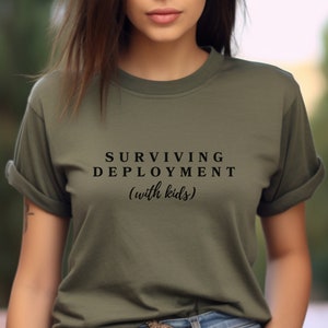 May include: A green t-shirt with the text "SURVIVING DEPLOYMENT (with kids)" printed in black.