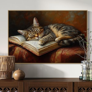This heartwarming art print captures a peaceful kitten sleeping on an open book. The soft lighting and cozy atmosphere make this piece perfect for book lovers and cat enthusiasts alike. The detailed brushstrokes highlight the kitten’s fluffy fur, creating a charming and serene scene. Whether for a reading nook, bedroom, or study, this print adds warmth and relaxation to any space. A perfect gift for literature lovers, pet owners, or anyone who appreciates quiet, dreamy moments.