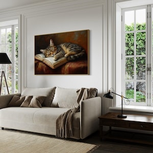 This heartwarming art print captures a peaceful kitten sleeping on an open book. The soft lighting and cozy atmosphere make this piece perfect for book lovers and cat enthusiasts alike. The detailed brushstrokes highlight the kitten’s fluffy fur, creating a charming and serene scene. Whether for a reading nook, bedroom, or study, this print adds warmth and relaxation to any space. A perfect gift for literature lovers, pet owners, or anyone who appreciates quiet, dreamy moments.