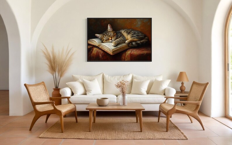 This heartwarming art print captures a peaceful kitten sleeping on an open book. The soft lighting and cozy atmosphere make this piece perfect for book lovers and cat enthusiasts alike. The detailed brushstrokes highlight the kitten’s fluffy fur, creating a charming and serene scene. Whether for a reading nook, bedroom, or study, this print adds warmth and relaxation to any space. A perfect gift for literature lovers, pet owners, or anyone who appreciates quiet, dreamy moments.