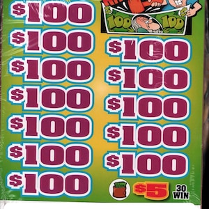 May include: A green and yellow scratch-off lottery ticket with the text "Hit the Loot." The ticket features multiple $100 prize amounts in a purple font. The ticket also has a $5 prize amount and a "30 Win" indicator.
