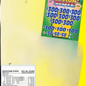 May include: A green and yellow Keystone State scratch-off lottery ticket with various prize amounts. The ticket displays the text "KEYSTONE STATE" and the prize amounts of $300, $100, and $50. The ticket also includes payout information.