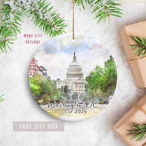 May include: A round ceramic ornament featuring a watercolor painting of the US Capitol Building in Washington, DC. The ornament has the text "Washington DC 2024" on it.