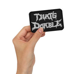May include: A black embroidered patch with white lettering that reads "That's Dope".