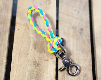 May include: A bright yellow, pink, and blue braided rope leash with a silver swivel clip.