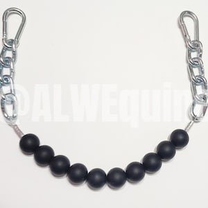 May include: A black beaded chain with silver-coloured metal chain links and clasps. The chain is curved, with the black beads forming the curve's base. The clasps are at each end of the chain. The background is plain white.