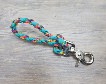 May include: A turquoise braided rope leash with a rainbow pattern and a silver swivel clip.