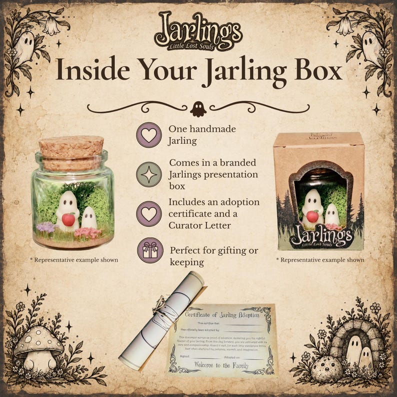 May include: A Jarlings Little Lost Souls product display featuring a glass jar with a cork lid containing two white ghost figures, one holding a red apple, on green moss. Includes a branded cardboard box, a rolled scroll, and an adoption certificate.