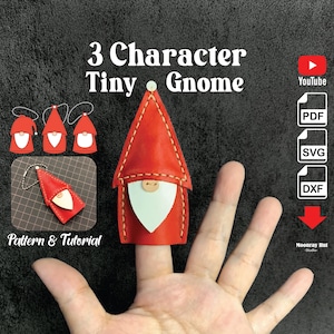 May include: A hand wearing a red leather finger puppet gnome with a white beard and a button nose. The gnome is part of a set of three character tiny gnomes. The image also includes the text "3 Character Tiny Gnome", "Pattern & Tutorial", "YouTube", "PDF", "SVG", "DXF", and "Moonray Hut Studio".