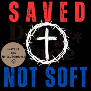 May include: Digital design on a black background with the words "SAVED" in red and "NOT SOFT" in blue. A white cross is centered within a white crown of thorns. A brown circle reads "INSTANT PNG DIGITAL DOWNLOAD".
