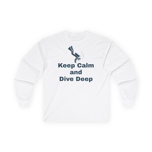 May include: White long-sleeve t-shirt with a scuba diver graphic and the text "Keep Calm and Dive Deep".