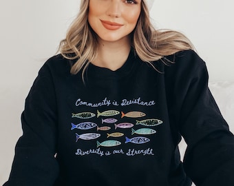 Sudadera Sardina "Comunidad es Resistencia": anti Trump, anti ICE, regalo demócrata