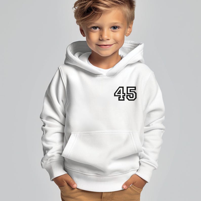 May include: A white hooded sweatshirt with a front pocket and the number "45" printed in black on the front. The sweatshirt is worn by a young child. The background is a solid light gray.