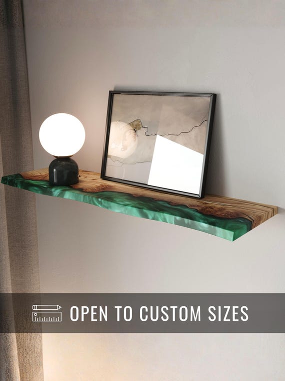 Vivid green epoxy river meets live-edge wood — a shelf that doubles as wall art and moonlights as a projector perch.