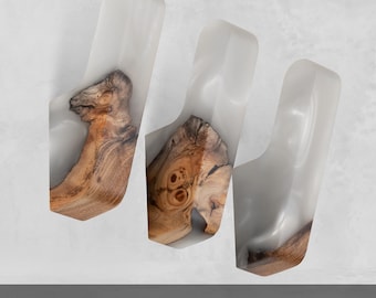 May include: Three wall hooks featuring a combination of natural light brown wood with visible grain and smooth, translucent white resin. Each hook has a curved, elongated shape with a distinct wooden base and a resin top. The text FAST DELIVERY is visible.