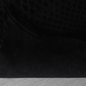 May include: Black fabric with a subtle leopard print pattern. The fabric is folded in half, showing the smooth texture of the material.