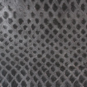 May include: Black leather with a textured, embossed pattern of small circles.
