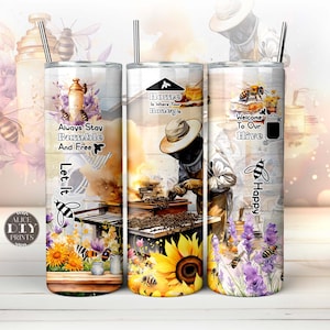 May include: Three stainless steel tumblers with colorful bee-themed designs. The first tumbler features a bee and the text "Always Stay Bumble And Free Let It". The second tumbler features a beekeeper working a beehive with the text "Home Is Where Your Honey Is". The third tumbler features a bee and the text "Welcome To Our Hive Happy".