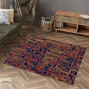 Può includere: Un tappeto blu con un motivo a circuito stampato in arancione e giallo. Il tappeto è su un pavimento in legno.