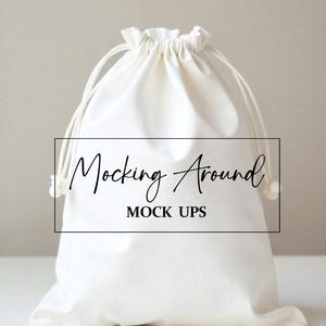 May include: White drawstring bag with the text "Mocking Around Mock Ups" printed on the front.