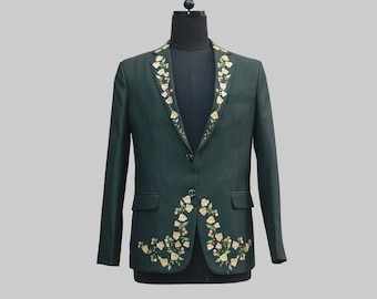 May include: A dark green blazer with a floral embroidered collar and matching floral embroidery on the front. The blazer has a single button closure.