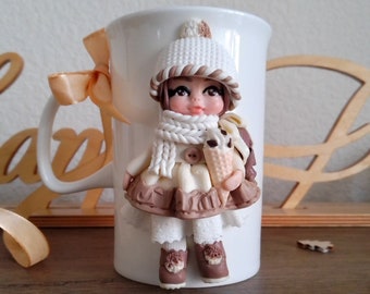 A cup with a 3d  doll made of polymer clay, a mug with a girl, a cup with decor