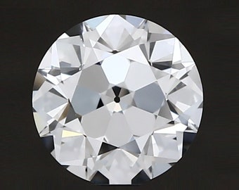 May include: A round, clear, faceted diamond gemstone with a black center.