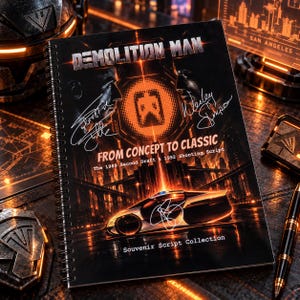 May include: A spiral-bound Demolition Man souvenir script collection book featuring a black cover with orange neon city graphics, a futuristic car, and signatures. The text reads Demolition Man, From Concept to Classic, The 1989 Second Draft & 1992 Shooting Script.