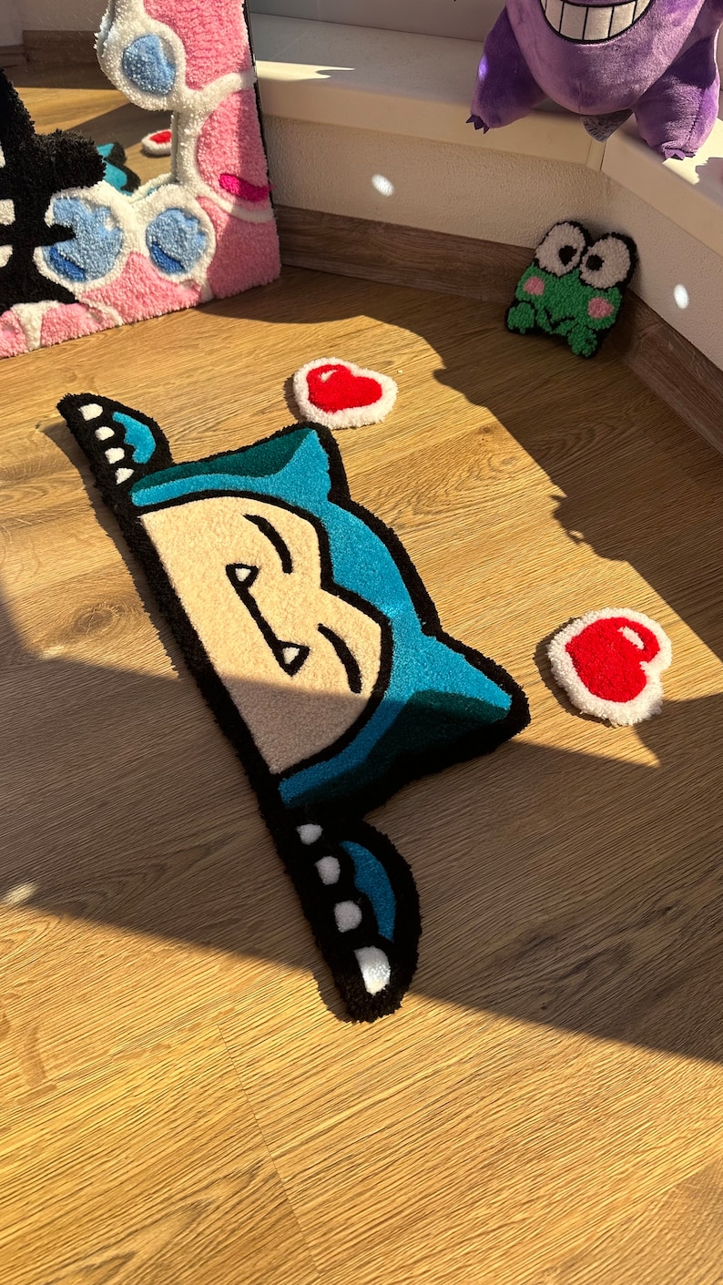 Unique handmade tufted rug in kawaii style, with sleepy blue character peeking and hearts around. Plush soft pile gives fluffy cozy comfort. Perfect as anime rug, cute carpet, or kawaii handmade décor. Great rug gift idea for couples, romantic vibe, or kawaii fans. Adds playful colorful accent, cozy charm, and cheerful energy to bedroom décor, nursery, or creative stylish spaces.