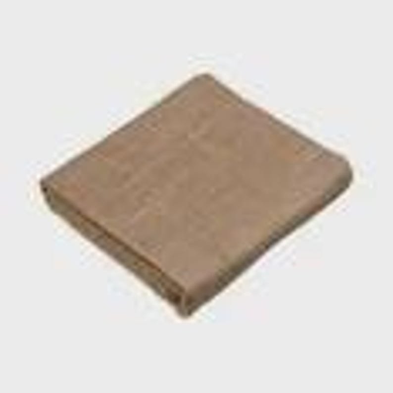 May include: Folded tan blanket. The blanket appears to be made of a woven material. The edges are neatly folded, and the blanket is rectangular in shape. The color is a neutral tan, suitable for various home decor styles.
