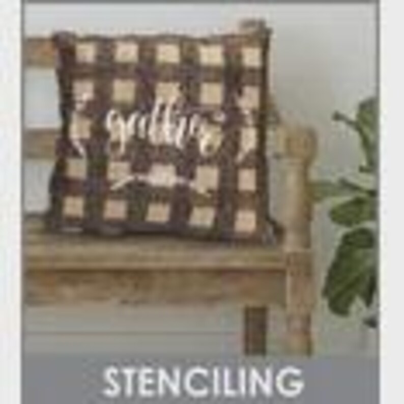 May include: A brown and tan plaid pillow with the word "gather" in a cursive font. The pillow is on a wooden bench. The word "STENCILING" is in a gray box at the bottom of the image.