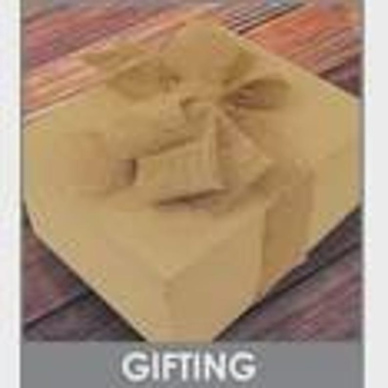 May include: A square, tan gift box with a matching burlap ribbon tied in a bow on top. The box is closed and ready for gifting. The word "GIFTING" is in a gray box at the bottom of the image.