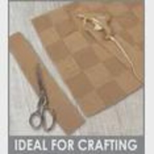 May include: A craft project setup featuring a tan cork sheet with a checkerboard pattern, a strip of cork, and scissors. A glue gun rests on the cork. The text "IDEAL FOR CRAFTING" is at the bottom.